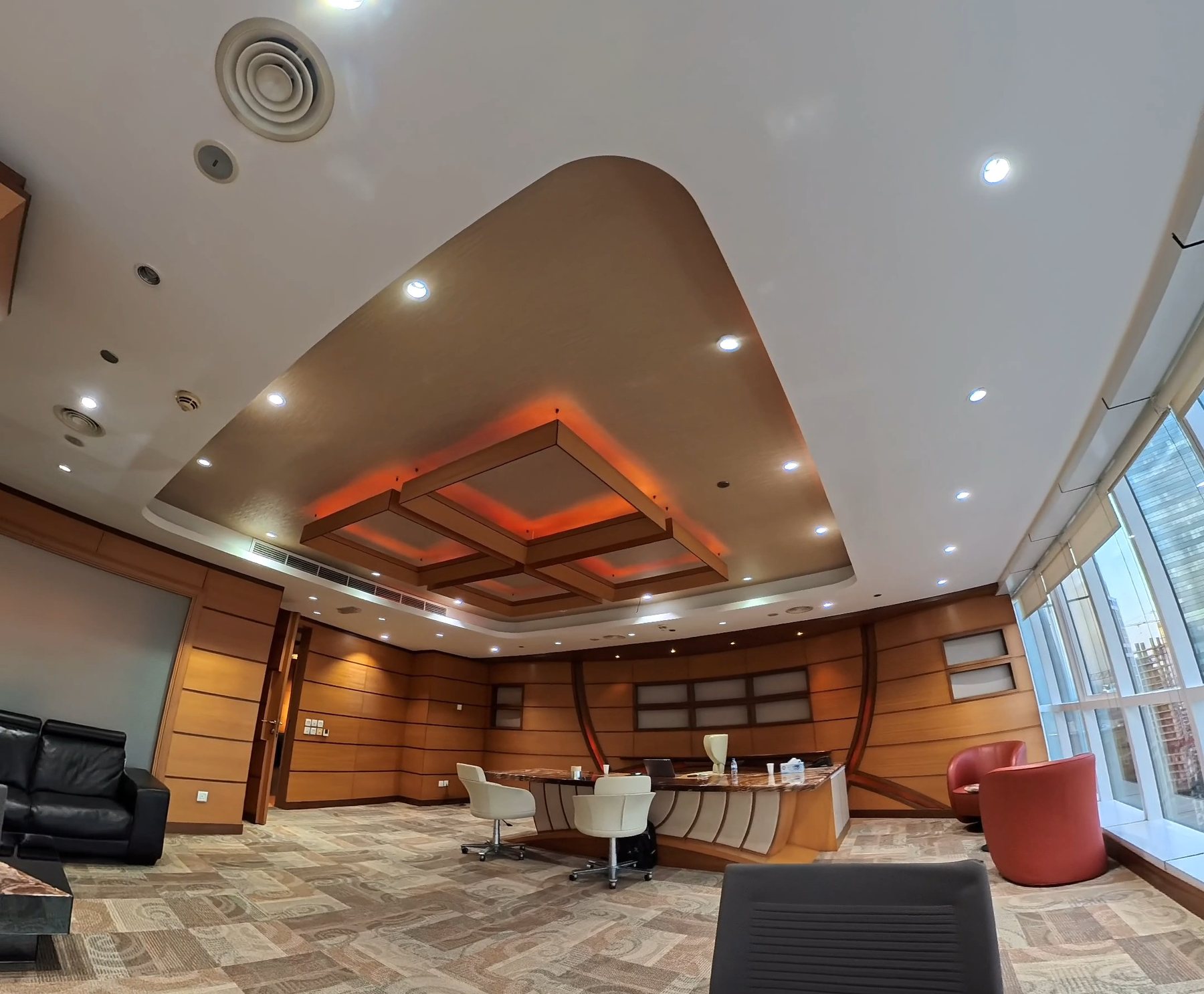 Vinyl-wrapped wall panelling and desk, warm wood finish